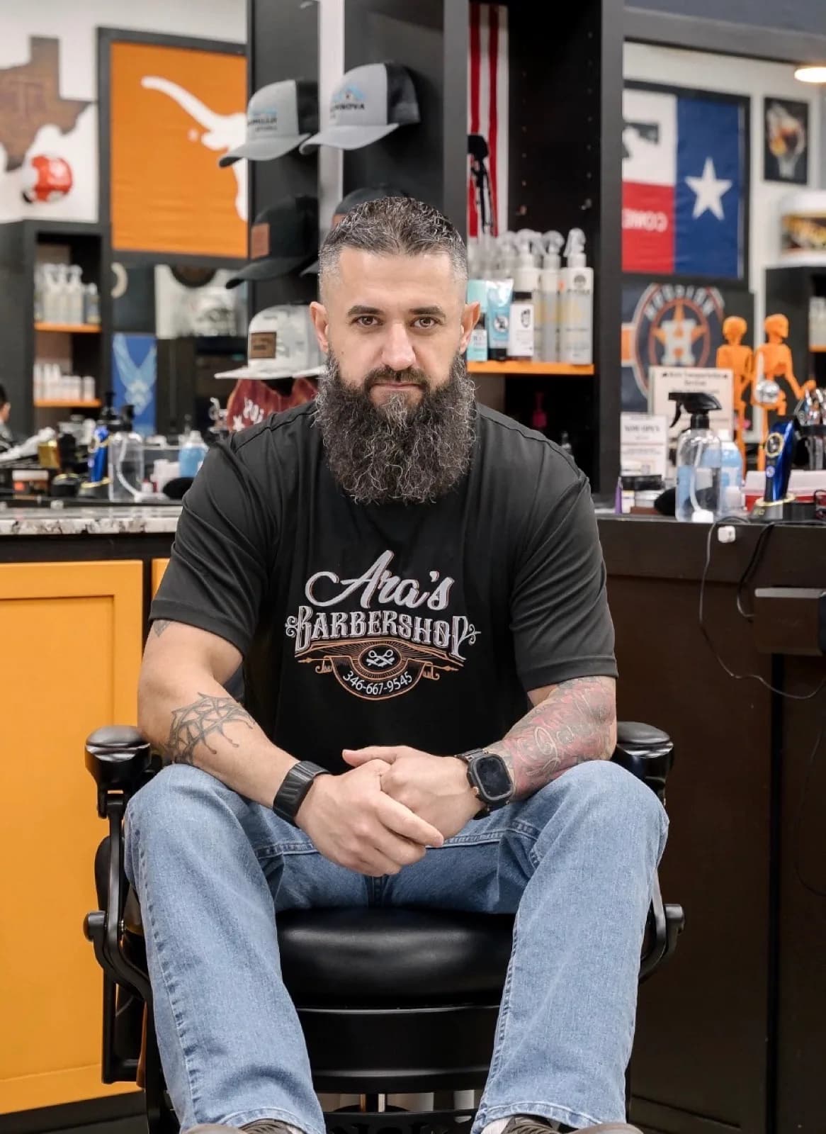 The owner of Aras Barbershop in the barber chair